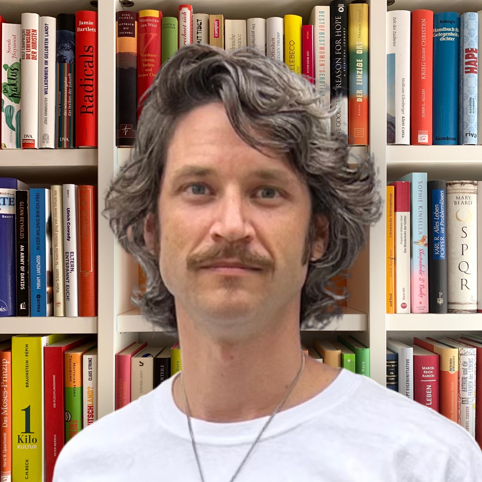 David Kochberg in front of a bookshelf